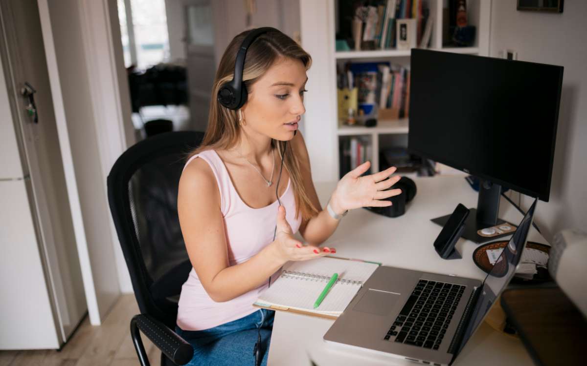 A young woman wearing head set in front of her laptop_Best Online Jobs For Teens