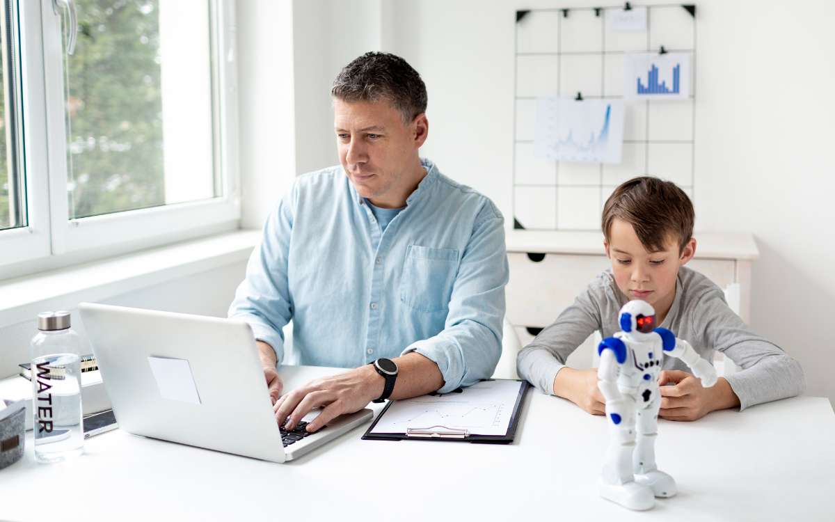 Legit Stay at Home Dad Jobs to Make Money_A man working at home using laptop and a boy beside him