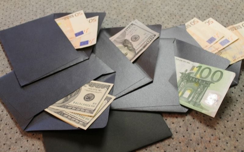Several black envelopes with bills on each of them