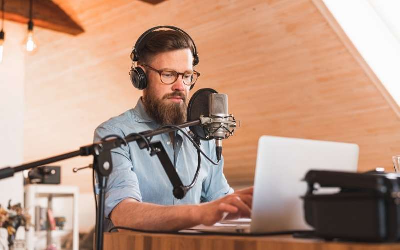 a man recording and broadcasting his podcast from home