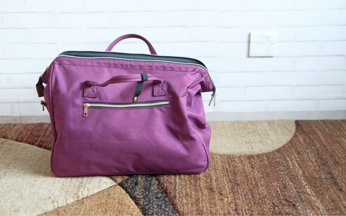 Photo showing a purple bag on the floor