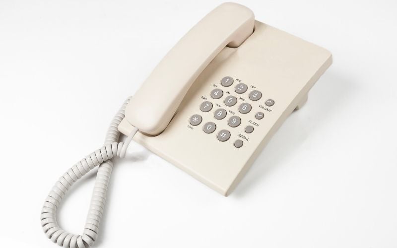 Photo of a white telephone in white background