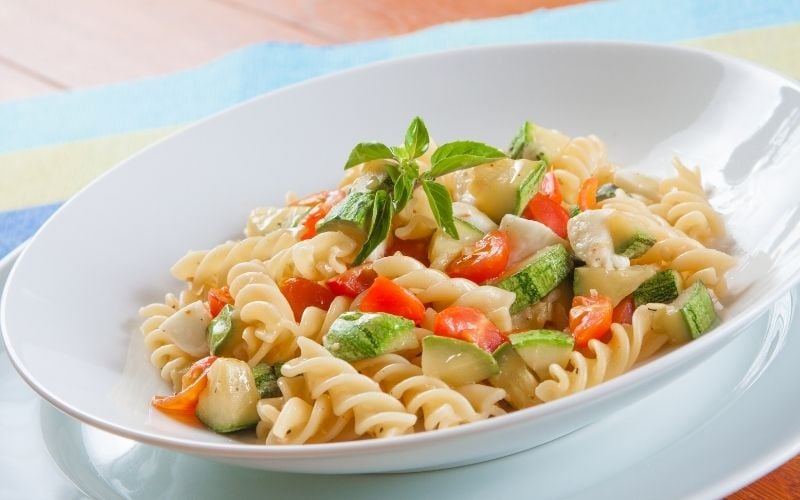 Photo of pasta and vegetables in white dish
