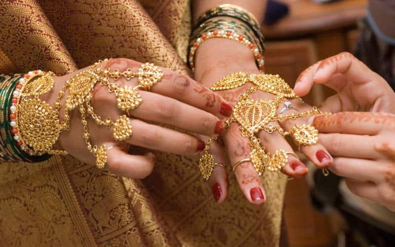 Phot of two pair of hands with accessories and decorations