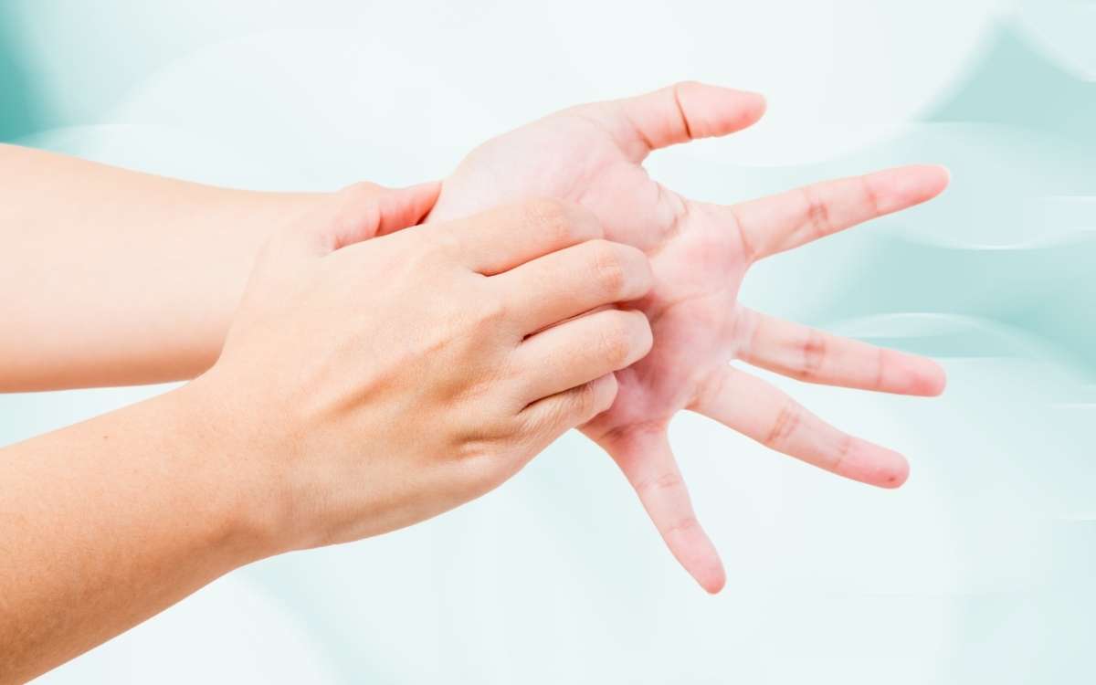 Photo of a hand scratching the palm of the other hand