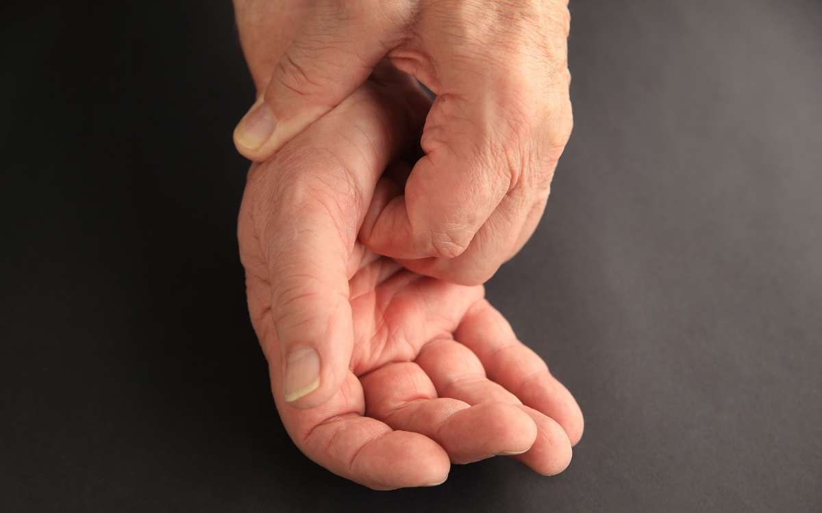 Photo showing a pair of hands with one hand scratching the palm