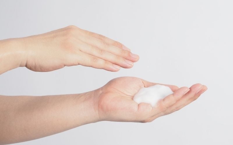 Photo of two hands with a lather on one hand