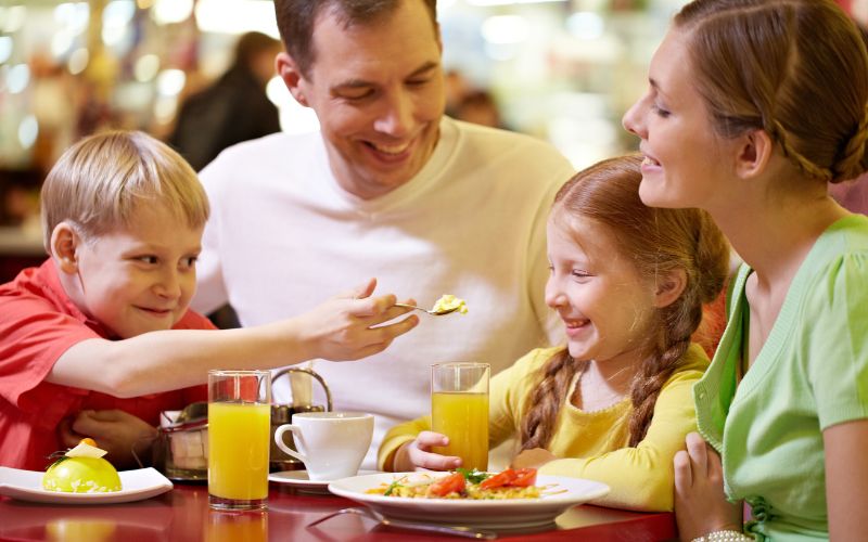 A family of four eating in a restaurant