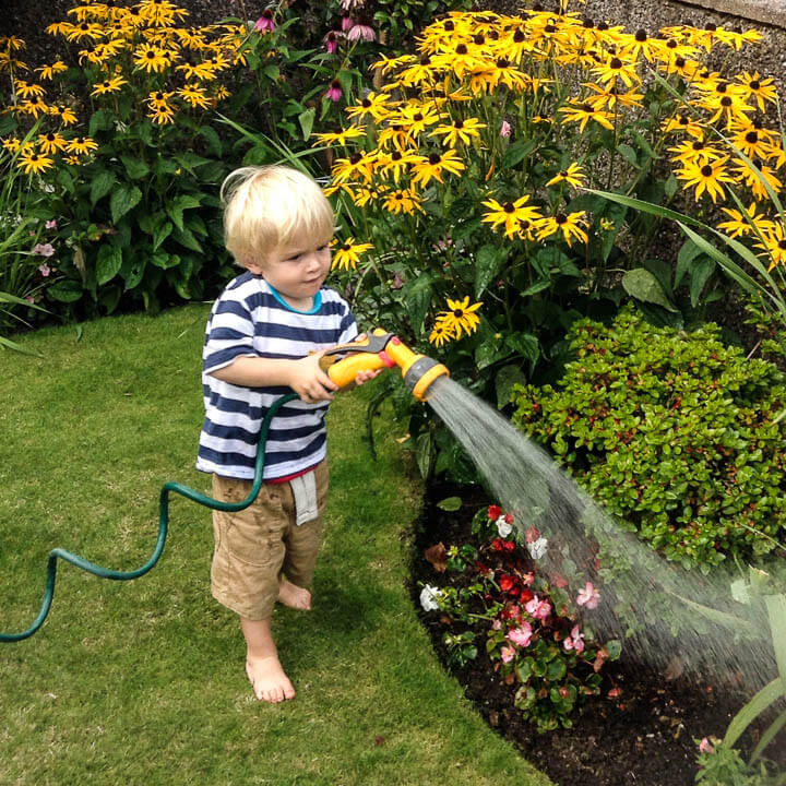 Toddler helping Nana with gardening in Cork, Ireland. Kids adapt to travel better than you expect.